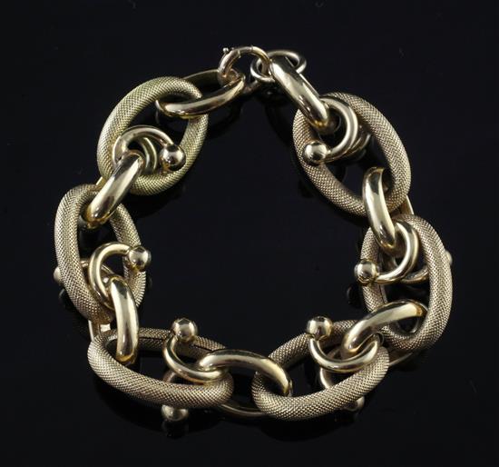 A stylish textured gold large oval link bracelet, 8.25in.
